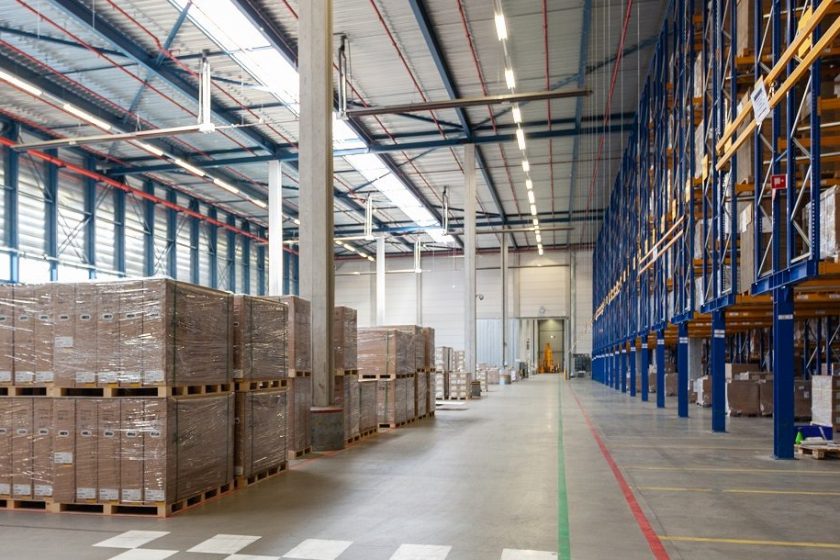 View of full warehouse with forklift